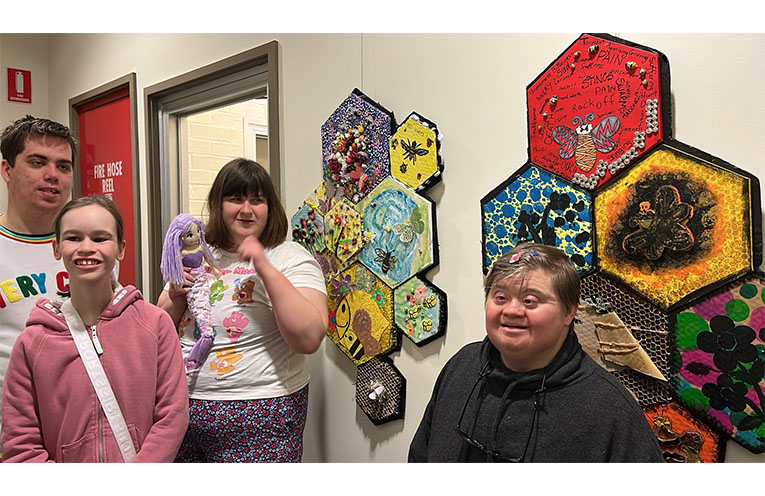 Participants Caleb, Imogen, Sarah and Cherylee proudly viewing their art works on display.