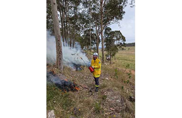 New Pindimar/Tea Gardens RFS recruit Jack using the drip torch to help build a fire break. Photo: Mark Pryor.