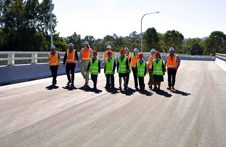 Local schoolchildren are some of the first to cross the bridge, alongside project team members and local politicians.