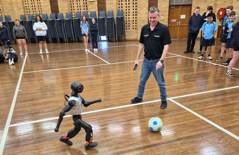 Students watching a robot chase a soccer ball. Photo: Nico Lombardo.