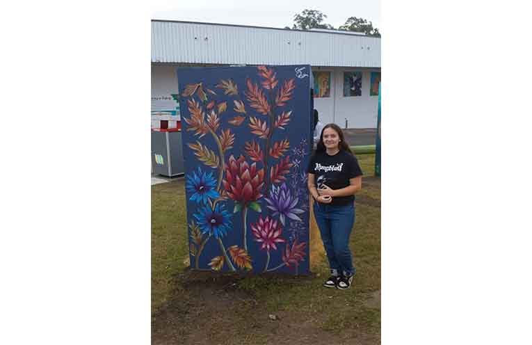 Emma Rose in front of her artwork. Photo: Nico Lombardo.