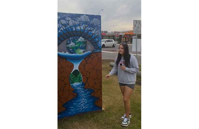 Nikki Bradshaw in front of her artwork. Photo: Nico Lombardo.