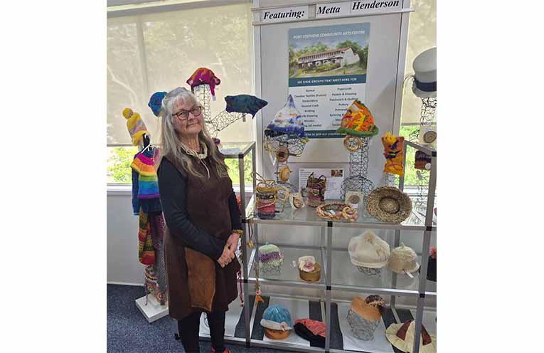 Metta Henderson in front of her creations, featured in the Botanical and Printmakers exhibition. Photo: Nico Lombardo.