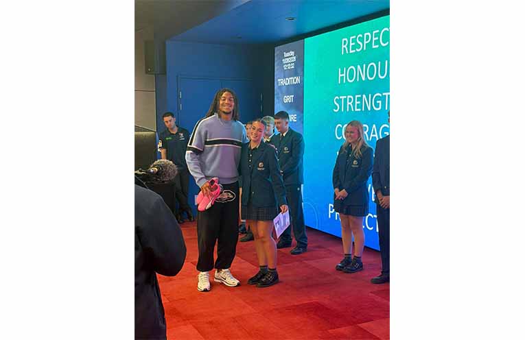 Students from Catherine McAuley Catholic College, Medowie present Newcastle Knights players with their hand-painted boots honouring Indigenous Round. Photos: CMCC Facebook.