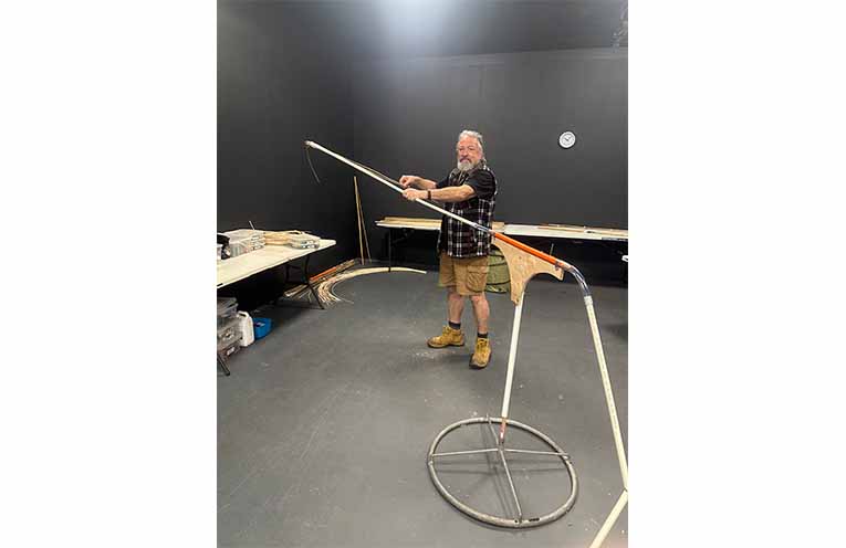 Artistic Director Phillip Relf at the beginning of the lantern build, holding up what will become the wing of the flying fox. Photo: Althea Guinsberg.