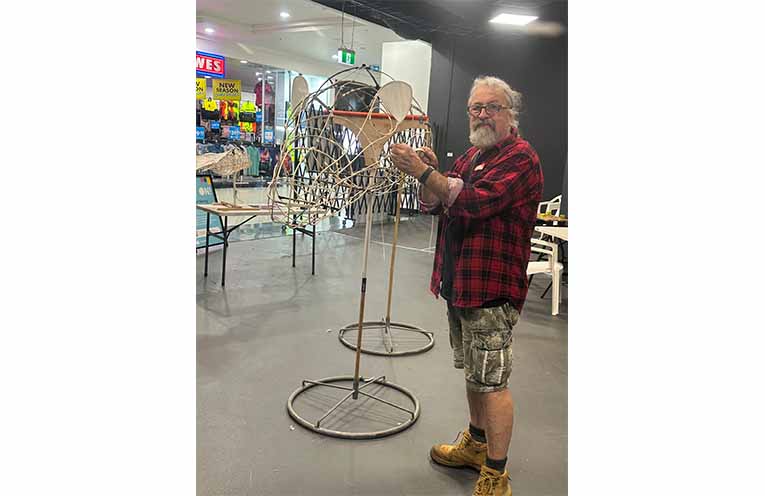 Phillip Relf standing next to the bamboo skeleton of the lantern. Photo: Althea Guinsberg.