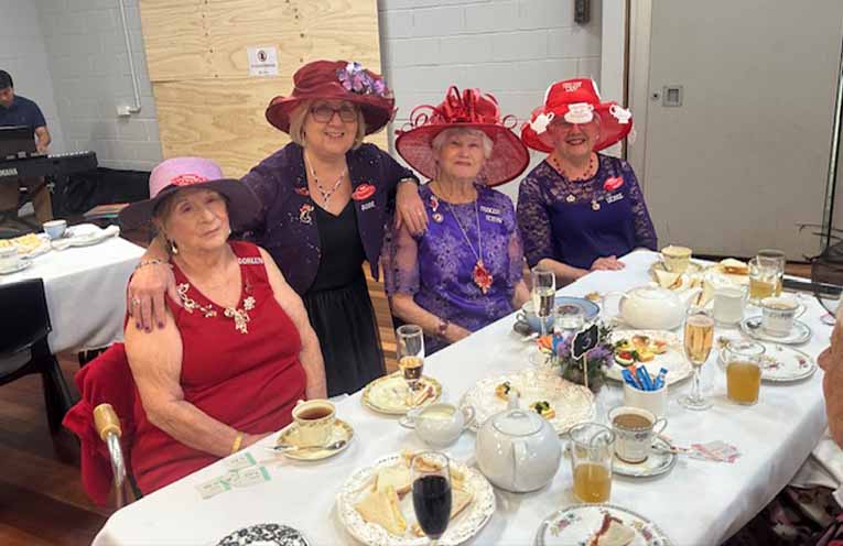 Members of the Red Hatters enjoying High Tea. Photo: Althea Guinsberg.