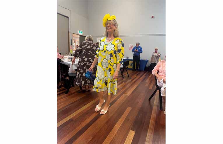 Eve takes to the floor to model one of the outfits and hats during the High Tea. Photo: Althea Guinsberg.