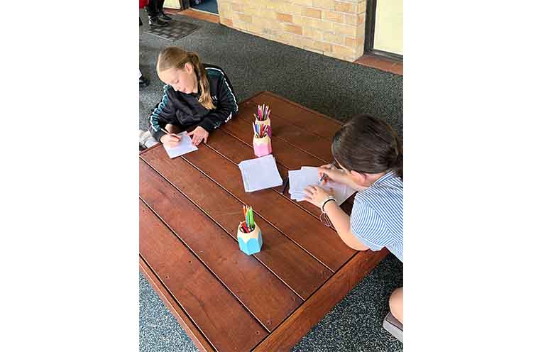 Aubree and Alexis enjoy the new outdoor library. Photo: Althea Guinsberg.