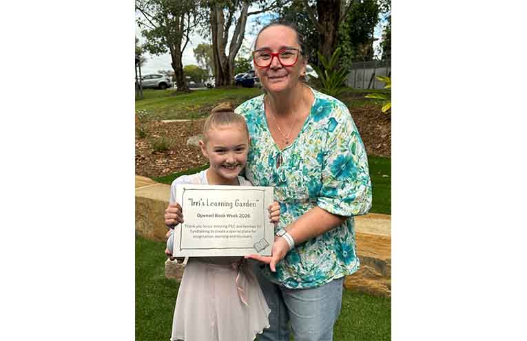 P&C President Kim Antonio with her granddaughter Iris and the plaque marking the opening of Irri’s Learning Garden. Photo: Althea Guinsberg.