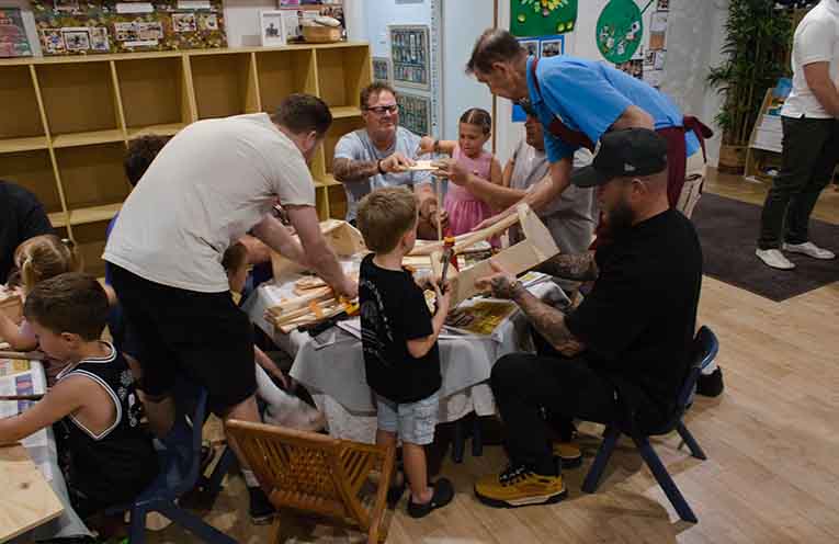 Fathers and children bonding together, thanks to woodworking. Photo: Nico Lombardo
