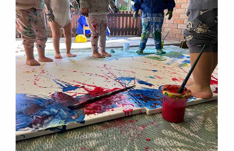 Tiny feet, bright colours and a lot of fun as children create their own colourful masterpieces. Photo: Salamander Early Education Centre.