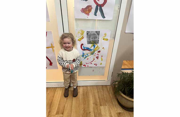 A young artist showing off their art. Photo: Althea Guinsberg.