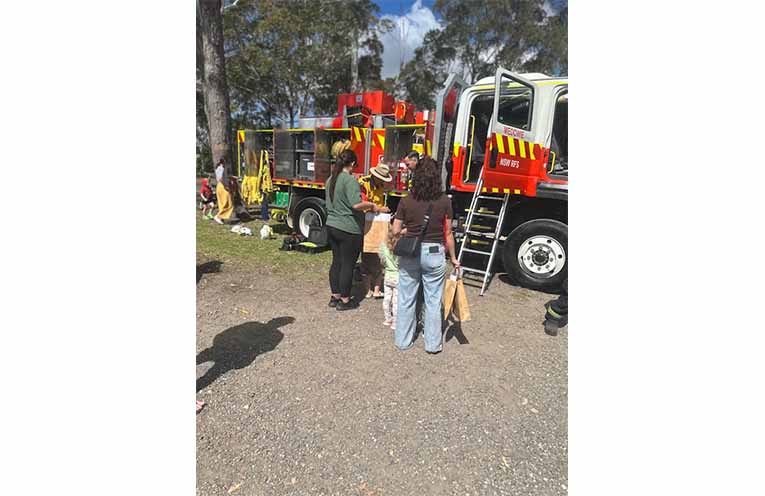 Locals inspect the equipment carried on fire trucks. Photo: Althea Guinsberg.