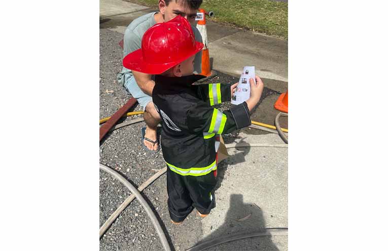 A young aspiring firefighter enjoying the day’s activities. Photo: Althea Guinsberg.