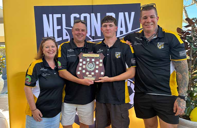 Nelson Bay FC under-16 boys team capped a memorable season by capturing a Newcastle Football Community inter-district championship double and the club’s Most Distinguished Team Award. Pictured, from left, are team manager Louise Farrell, head coach Chris Farrell, and assistant coaches Arran McKenzie and Jake Parmigiana. Photo: Nelson Bay FC.
