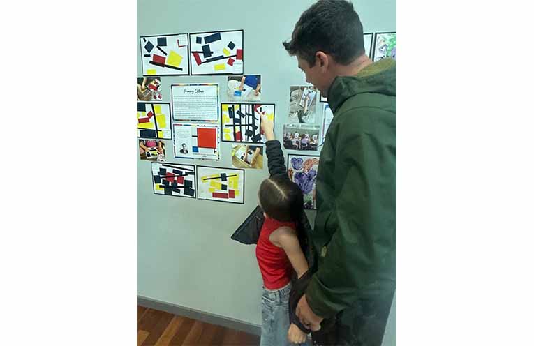 A young visitor points out artwork in the Medowie Preschool display. Photo: Althea Guinsberg.