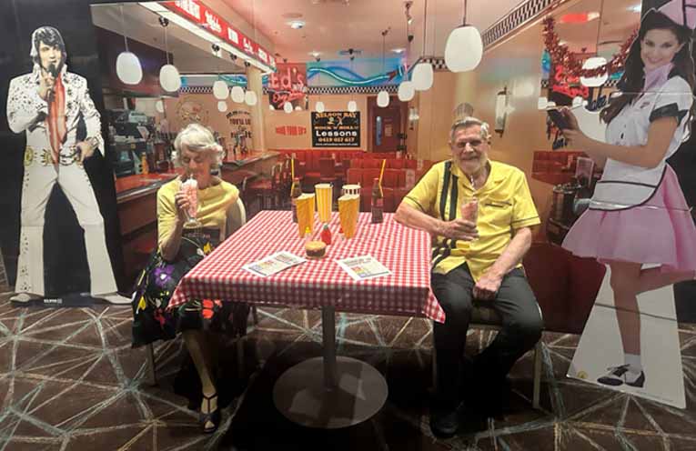 Dance instructors Diana and Keith Barnard pose in front of the retro diner backdrop at the Nelson Bay Rock ’n’ Roll Festival. Photo: Althea Guinsberg.