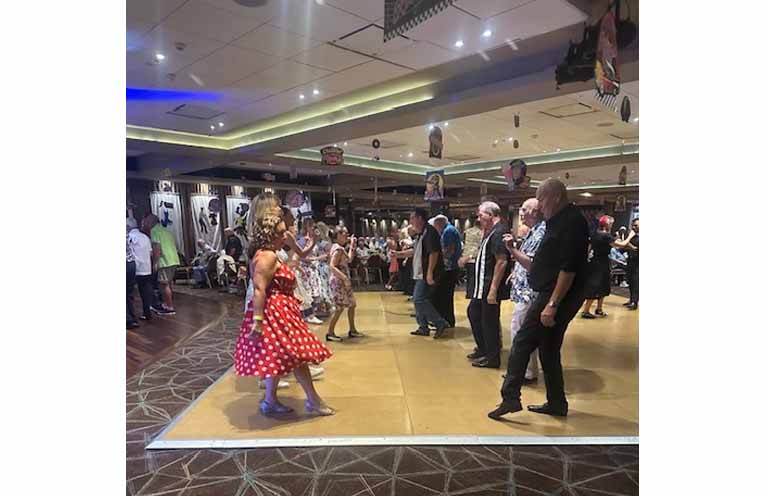 Dancers step to the beat as the music keeps the dance floor busy. Photo: Althea Guinsberg.