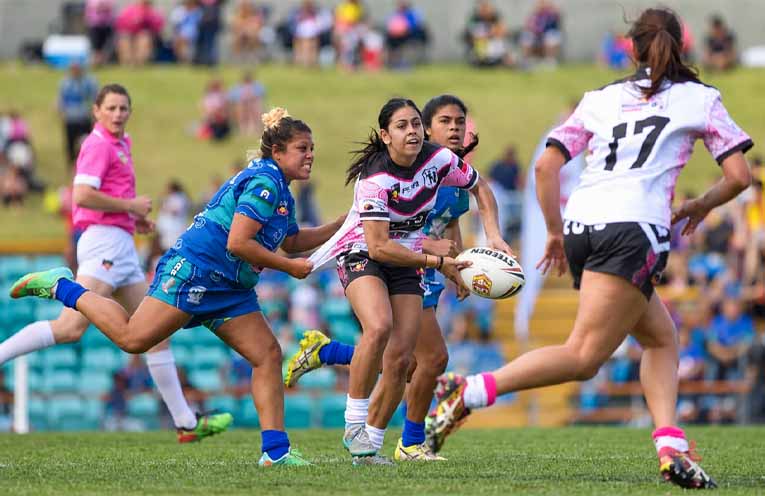 A player looks to pass as defenders close in during the women’s competition at the Koori Knockout. Photo:Althea Guinsberg.