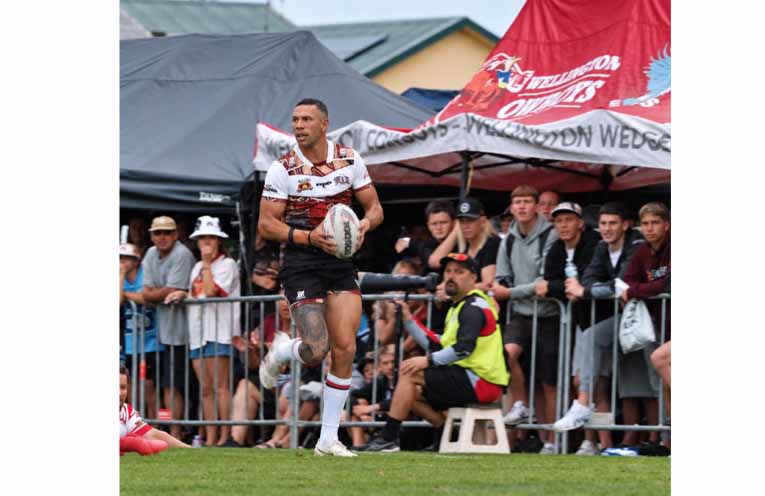 A ball carrier searches for a gap as spectators watch from the sidelines at King Park. Photo:Althea Guinsberg