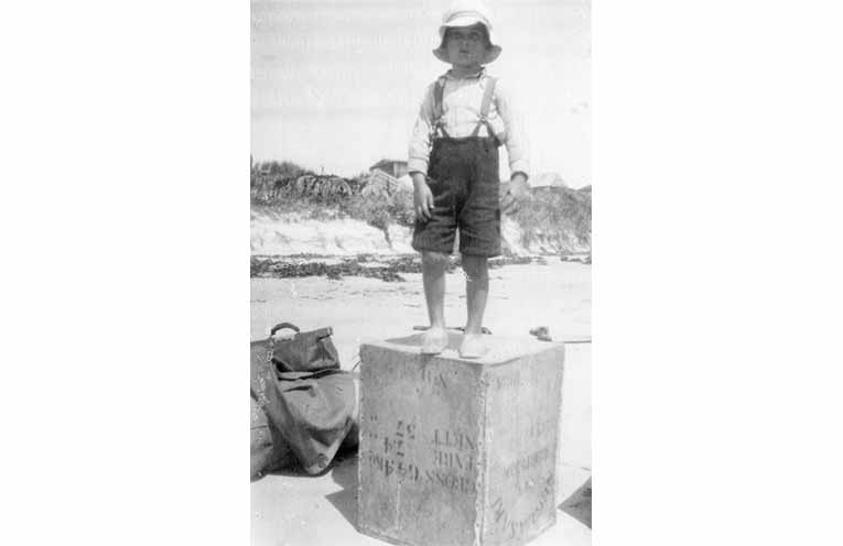 A young Max Catsicas on North Beach. Note the roofs of the shacks in the background. Photo: Supplied by John Clarke.